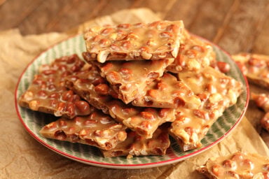 Pieces of Peanut Brittle on serving dish.