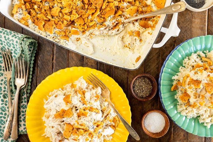Servings of Poppy Seed Chicken Casserole on colorful plates.