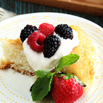 Skillet Cake with whipped topping and fruit on top