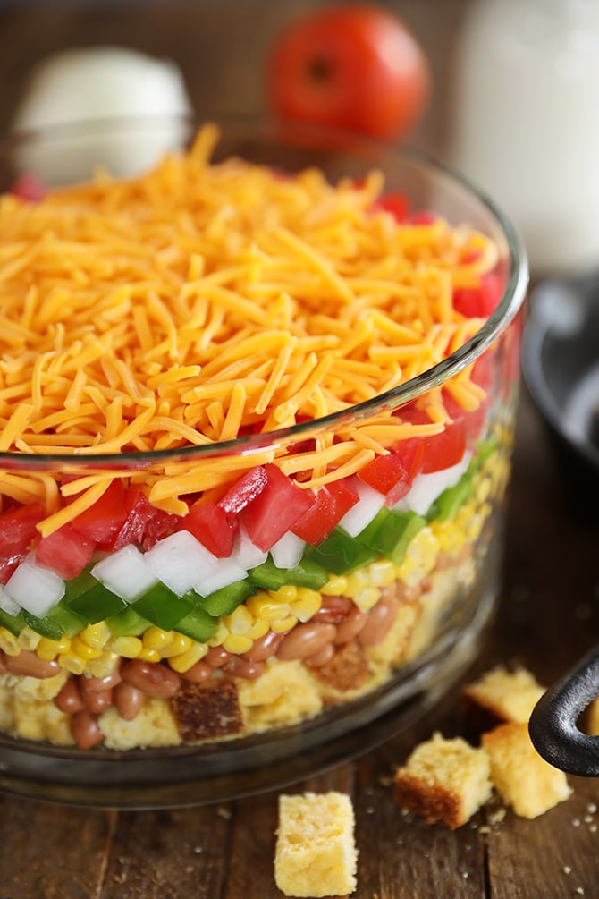 Layered Cornbread Salad in clear glass bowl