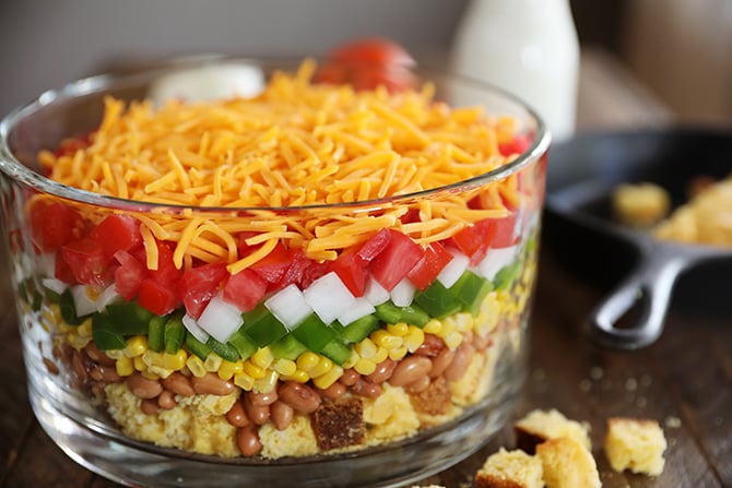 Layered Cornbread Salad in clear glass bowl