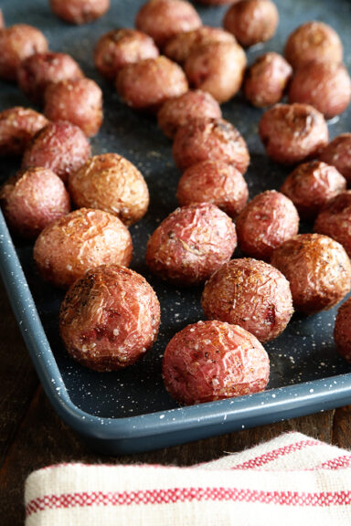 Roasted New Potatoes on baking pan close photo