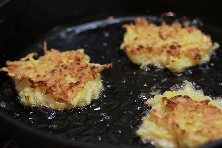Squash Fritters in a skillet.