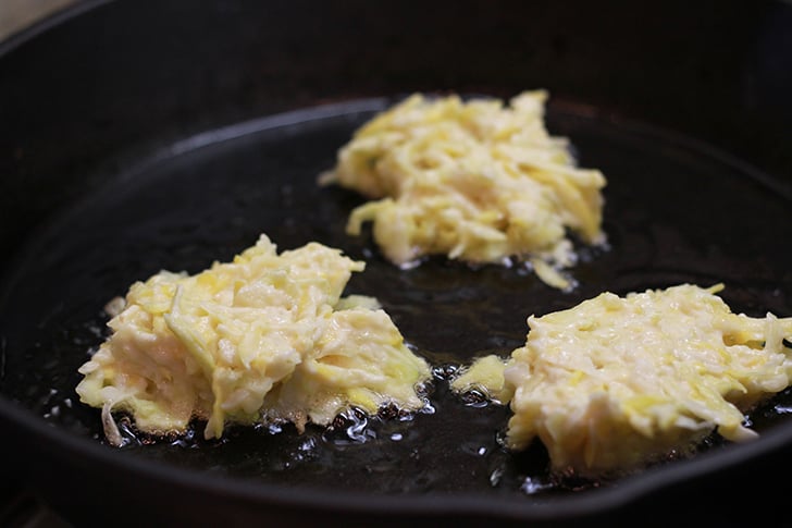 Squash Fritters in a skillet.