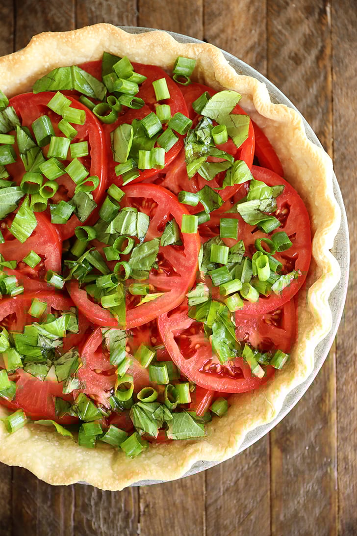 Tomatoes in pie crust with onions and basil.
