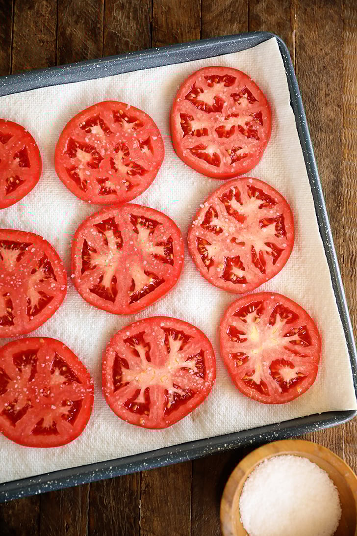 Sliced tomatoes on paper towels.