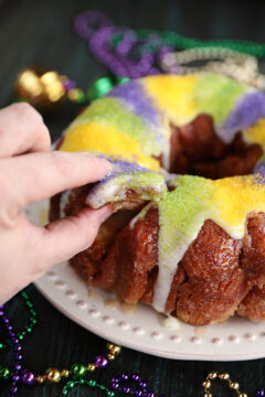 Taking a pinch of King Cake Pull Apart with fingers