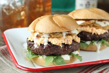 Put a little South in your mouth with this burger topped with pimiento cheese, fried green tomatoes, and Alabama White BBQ Sauce!