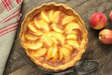 This Peach Chess Pie combines all the flavor of delicious peach cobbler in a decadent custard pie!