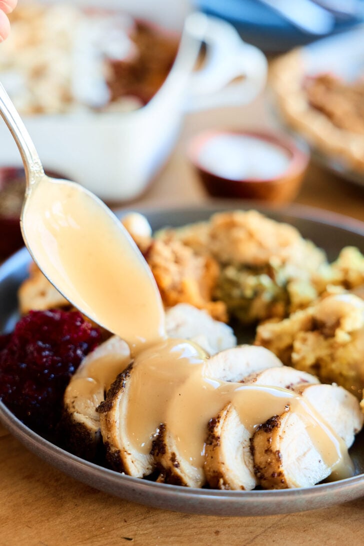 Slow Cooker Turkey Breast on plate with gravy.