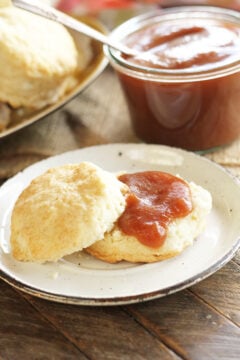 Slow Cooker Apple Butter on biscuit on white plate