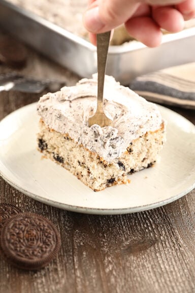 Cookies and Cream Sheet Cake slice with cookies beside plate