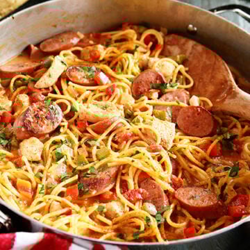 Creamy One Pot Jambalaya Pasta being served with spoon