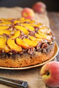 Peach Upside Down Cake with fresh peaches in background close photo