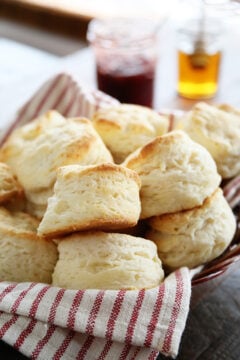 Easy Buttermilk Biscuits stacked in a basket