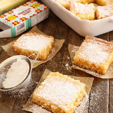 Slices of Gooey butter Cake dusted with powdered sugar