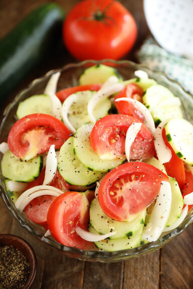 Tomto, Cucumer, and Onion Salad in a clear bowl