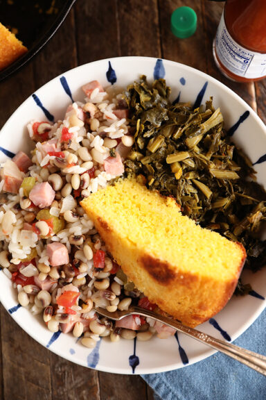Bolw of Hoppin John, collards, and cornbread.