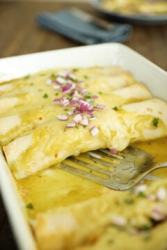 Creamy Chicken Enchiladas in a White Dish.