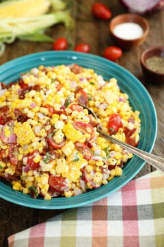 Sweet Corn Salad with Bacon in a teal bowl with a spoon in it