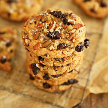 Stack of Chocolate, Cherry, Pistachio, Pecan Cookies on wire rack