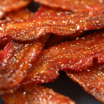 Easy Candied Bacon pieces on a blue plate.