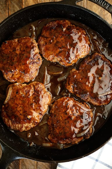 Salisbury Steak in a skillet.
