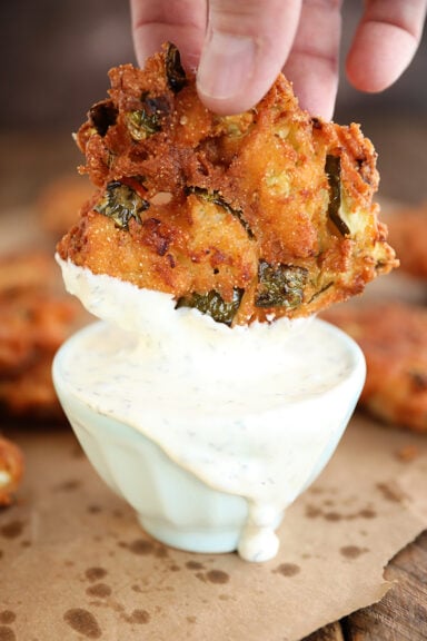 Fried Pickle Fritter being dipped in ranch.