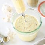 Filling a turkey injector with marinade.