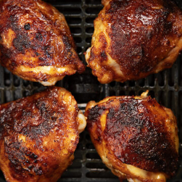 Chicken thighs in an air fryer with hot honey glaze.