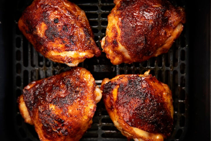 Chicken thighs in an air fryer with hot honey glaze. 
