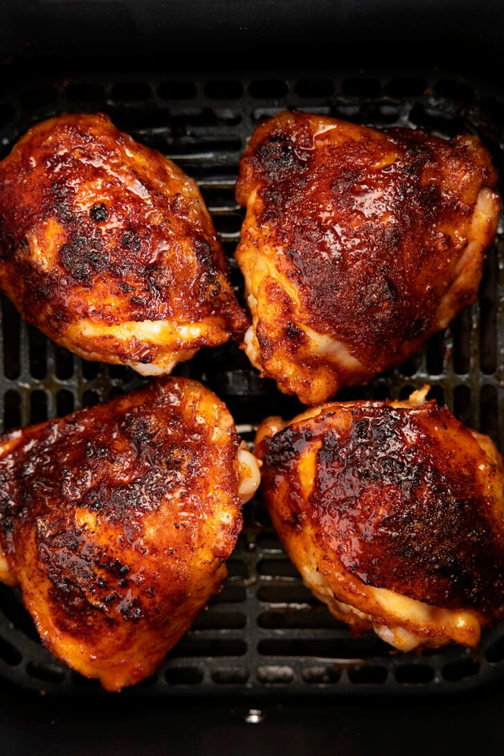 Chicken thighs in an air fryer with hot honey glaze.