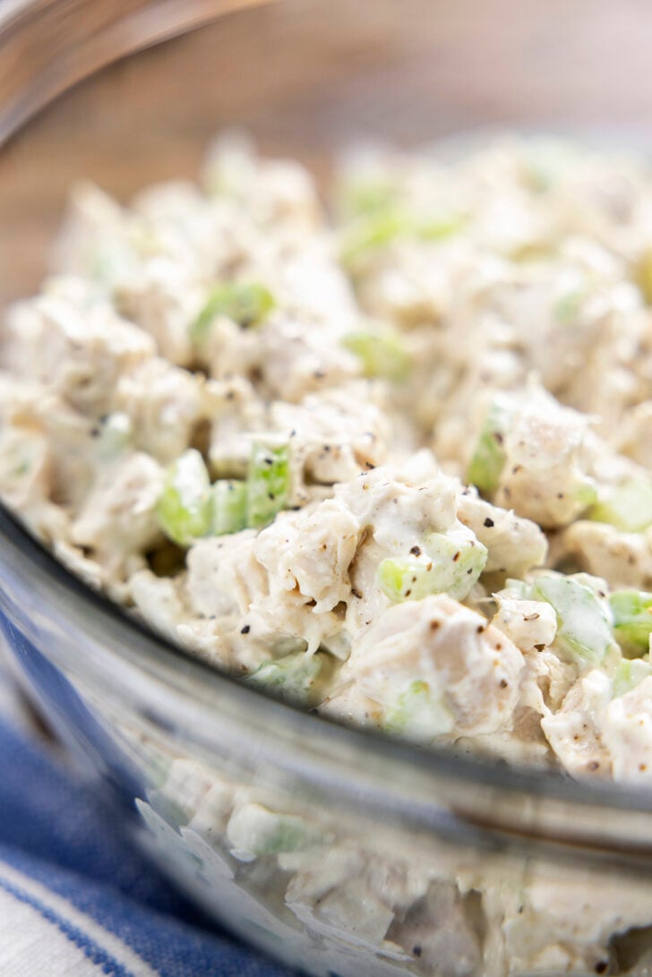 Close-up of chicken salad in a clear bowl.