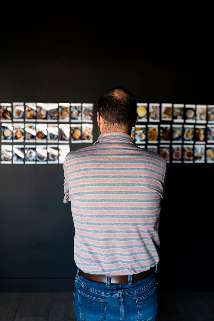 Stacey looking at images on wall.
